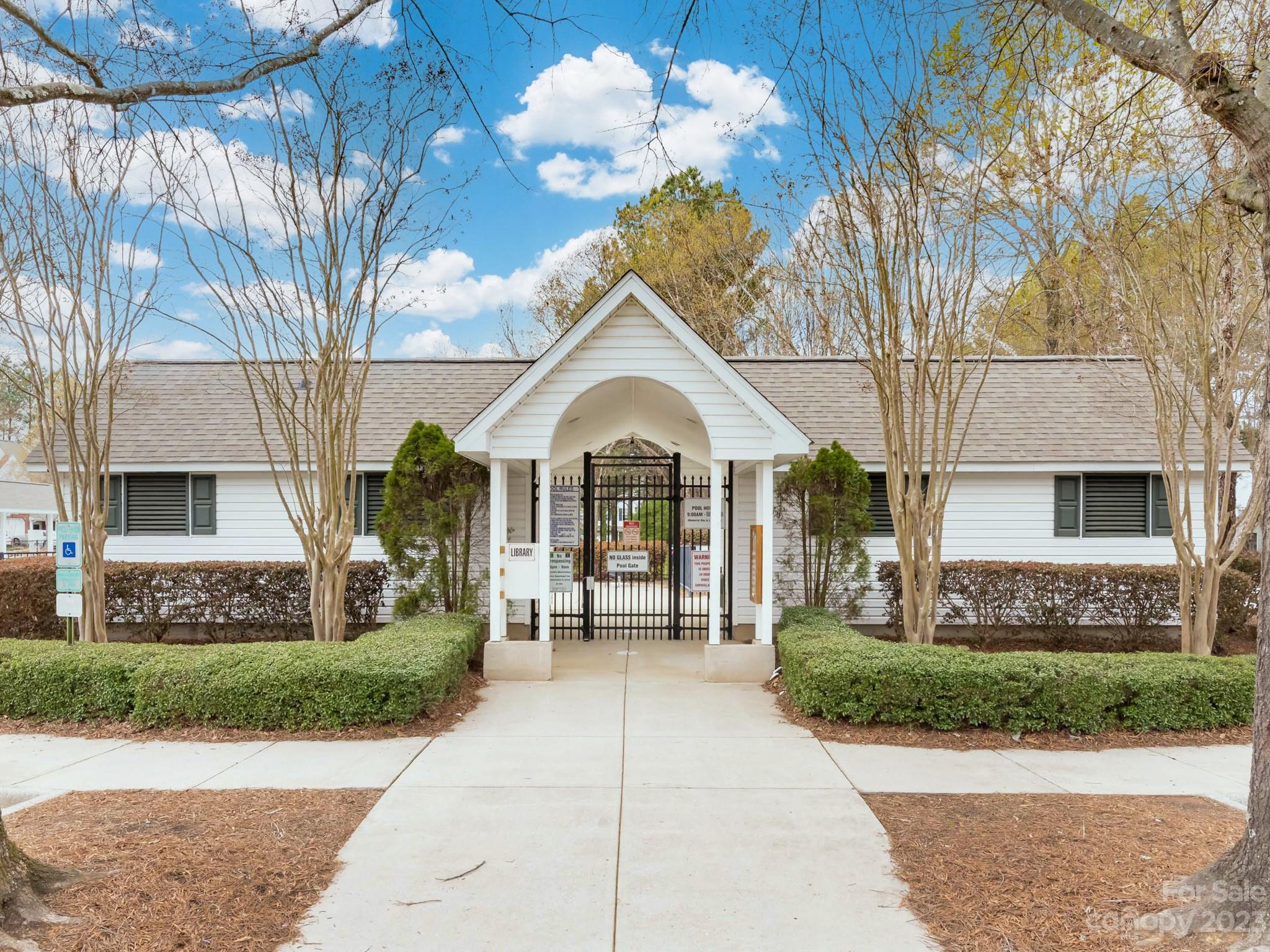 8158 Rudolph Road Charlotte, NC 28216 - Photo 18 of 23 a view of a house with a small yard and a large tree