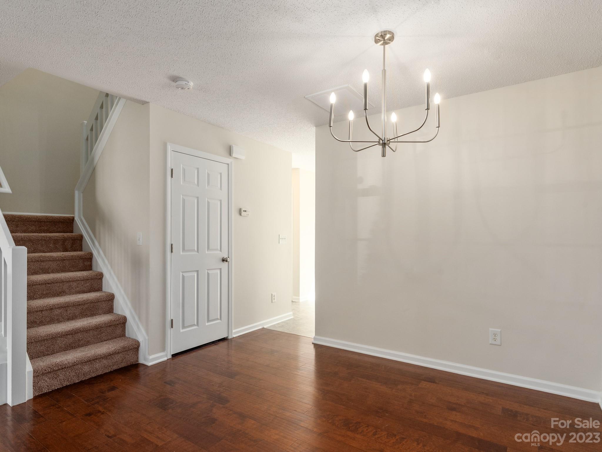 8158 Rudolph Road Charlotte, NC 28216 - Photo 4 of 23 wooden floor in an empty room with a window