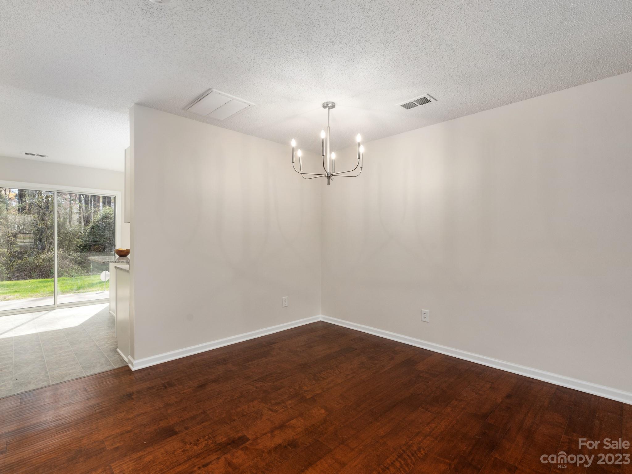 8158 Rudolph Road Charlotte, NC 28216 - Photo 5 of 23 a view of a room with wooden floor and windows