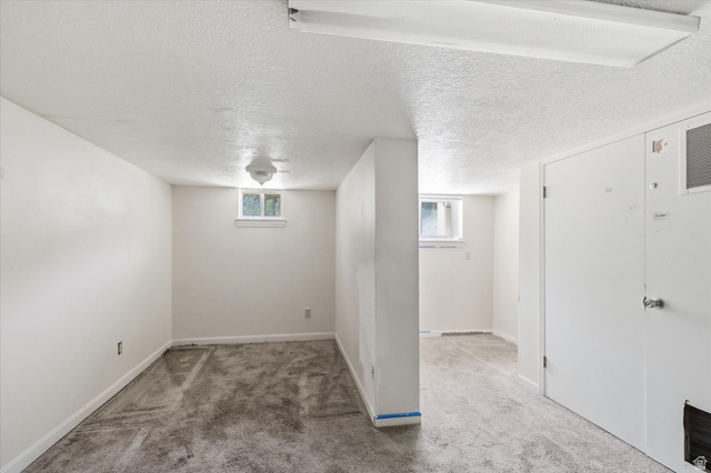 395 North 400 West Logan, UT 84321 - Photo 22 of 48 Finished interior space featuring textured ceilings and light-colored walls