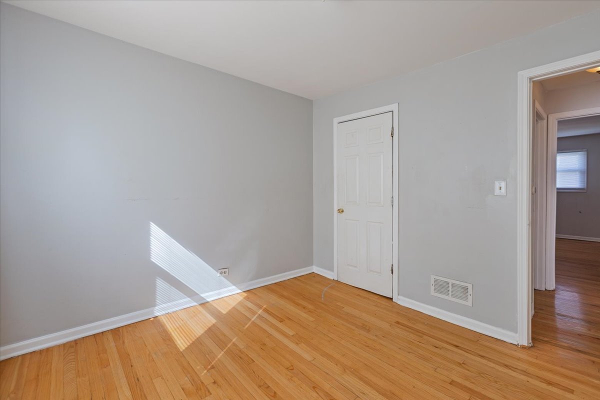 128 North Menard Avenue Chicago, IL 60644 - Photo 11 of 20 a view of empty room with wooden floor