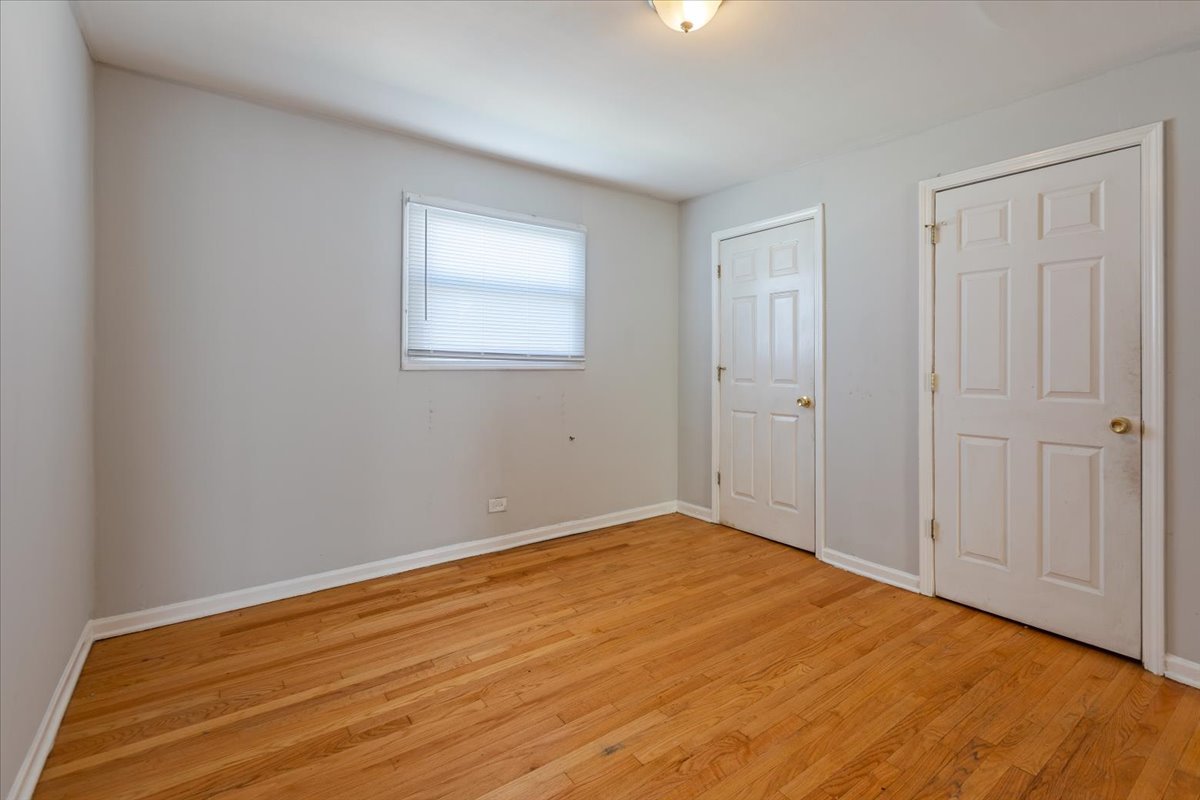 128 North Menard Avenue Chicago, IL 60644 - Photo 14 of 20 a view of empty room with wooden floor