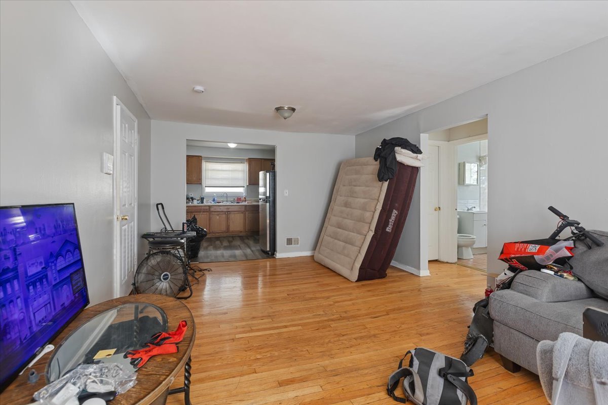128 North Menard Avenue Chicago, IL 60644 - Photo 15 of 20 a living room with furniture gym equipment and a wooden floor