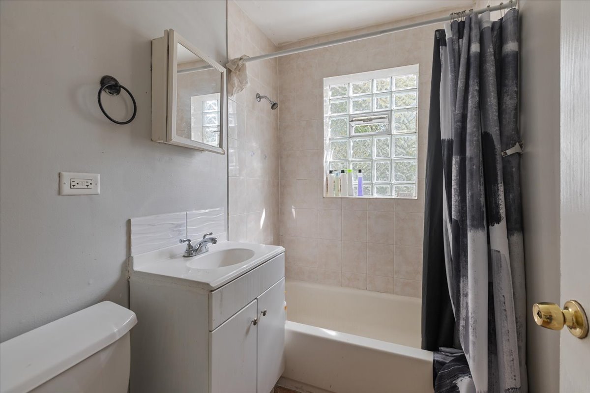 128 North Menard Avenue Chicago, IL 60644 - Photo 17 of 20 a bathroom with a sink a toilet and shower