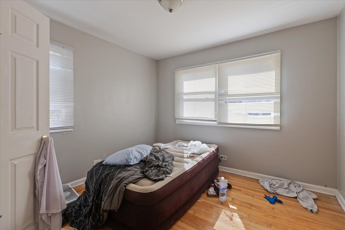 128 North Menard Avenue Chicago, IL 60644 - Photo 18 of 20 a bedroom with a bed and window