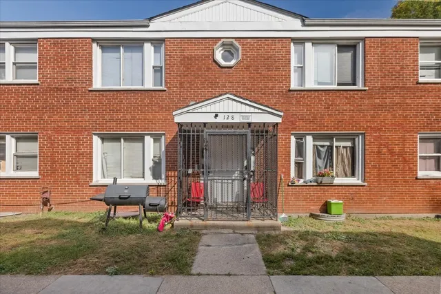a front view of a house with outdoor seating