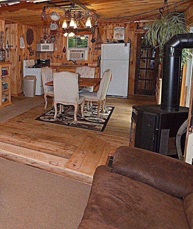153 Sir Walter Road Becket, MA 01223 - Photo 4 of 15 a view of a patio with table and chairs with wooden floor and fence