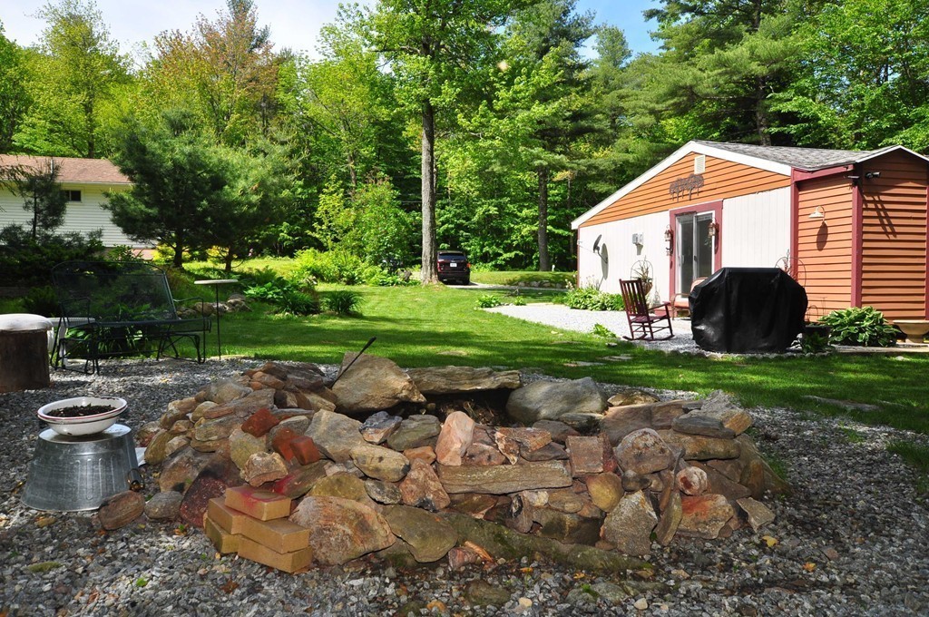 153 Sir Walter Road Becket, MA 01223 - Photo 8 of 15 a backyard of a house with yard and outdoor seating