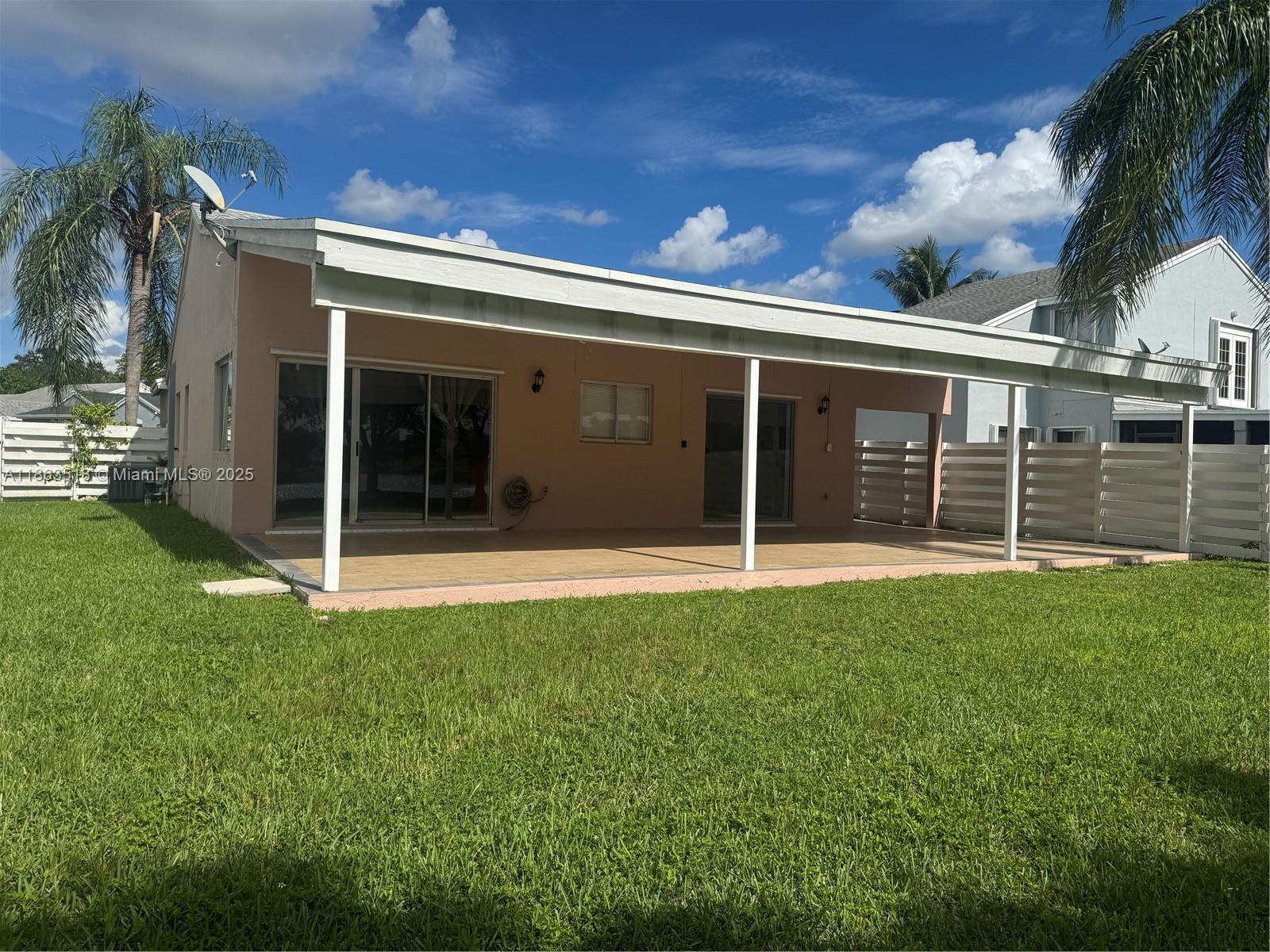 14570 Southwest 145th Place, Unit 14570 Miami, FL 33186 - Photo 14 of 23 a view of a house with a yard