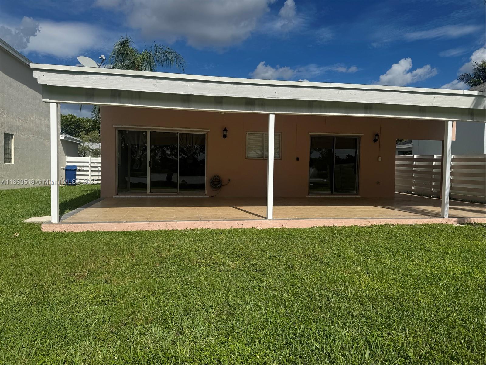14570 Southwest 145th Place, Unit 14570 Miami, FL 33186 - Photo 15 of 23 front view of a building with a garden