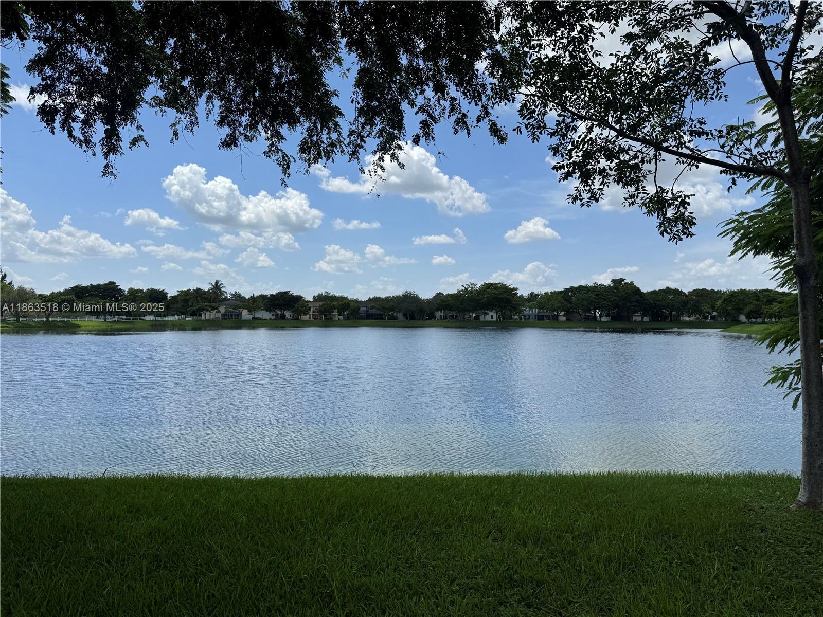 14570 Southwest 145th Place, Unit 14570 Miami, FL 33186 - Photo 2 of 23 a view of a lake from a yard