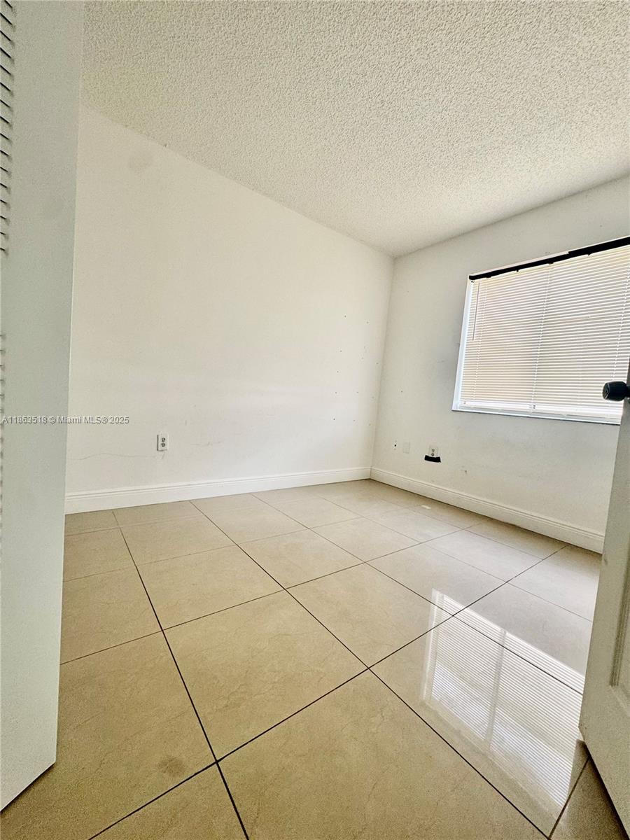 14570 Southwest 145th Place, Unit 14570 Miami, FL 33186 - Photo 6 of 23 a view of room and garage
