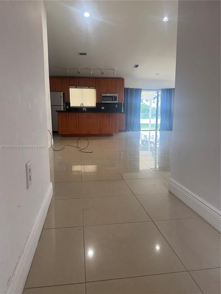 14570 Southwest 145th Place, Unit 14570 Miami, FL 33186 - Photo 8 of 23 a view of a living room a window and a television