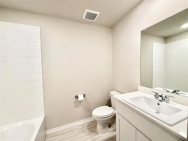 a bathroom with a bathtub and shower