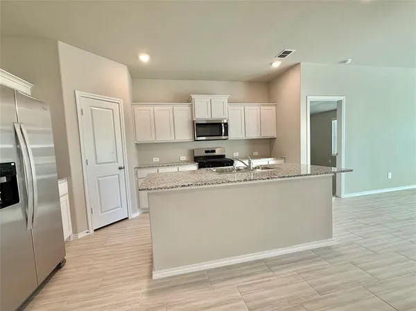 a view of kitchen and wooden floor