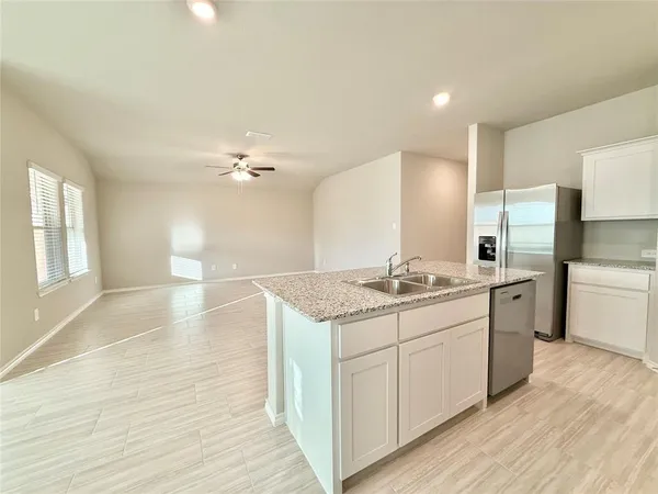 a kitchen with a sink and refrigerator