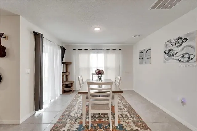 a living room with furniture and view of kitchen