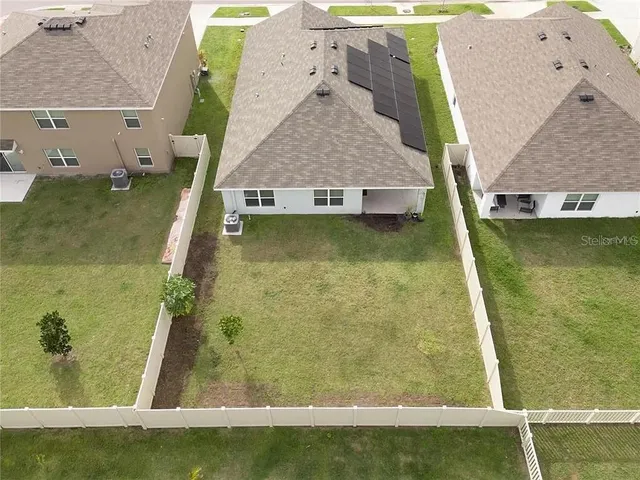 an aerial view of residential houses with outdoor space and river