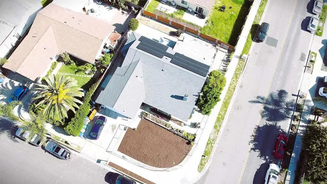 an aerial view of a house with a yard and garden