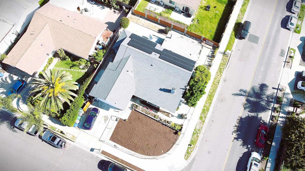 an aerial view of a house with a yard and garden
