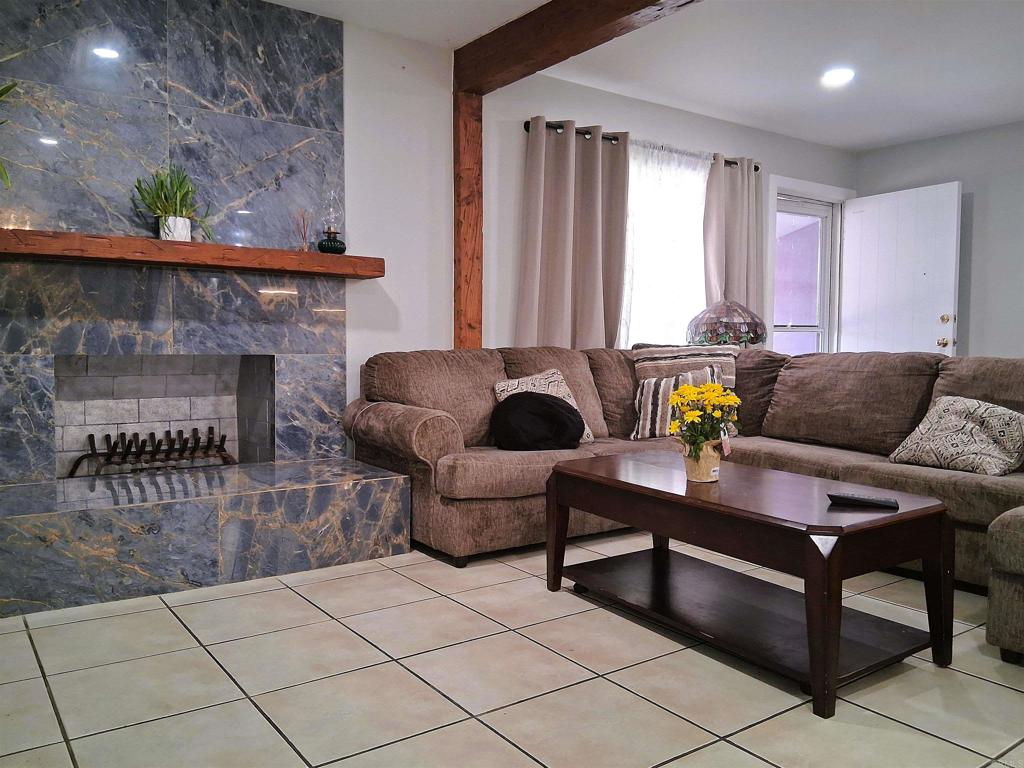 101 Lancer Avenue Oceanside, CA 92058 - Photo 4 of 17 a living room with furniture and a fireplace