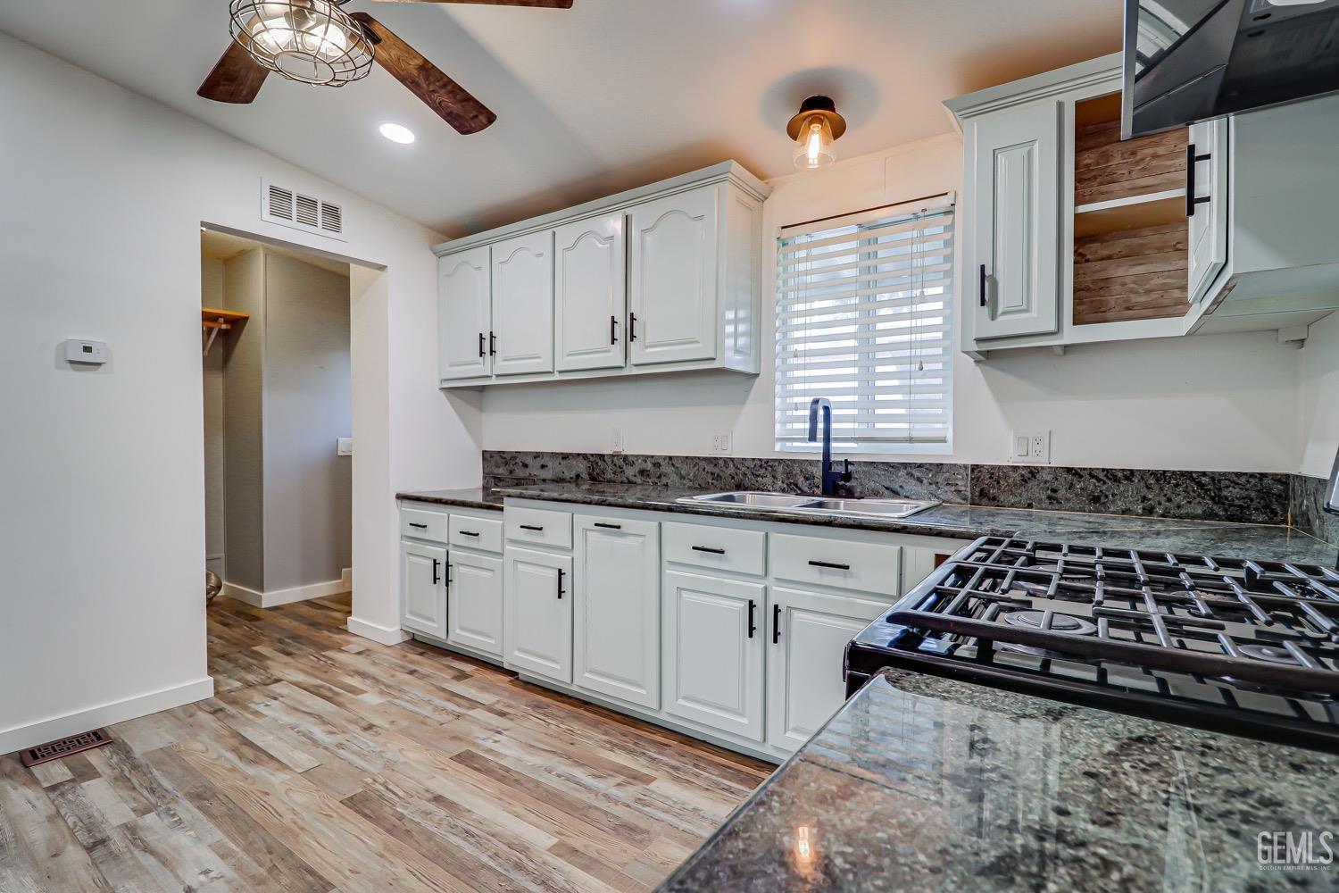Undisclosed Address Bakersfield, CA 93314 - Photo 12 of 27 a kitchen with stainless steel appliances granite countertop a stove and a sink