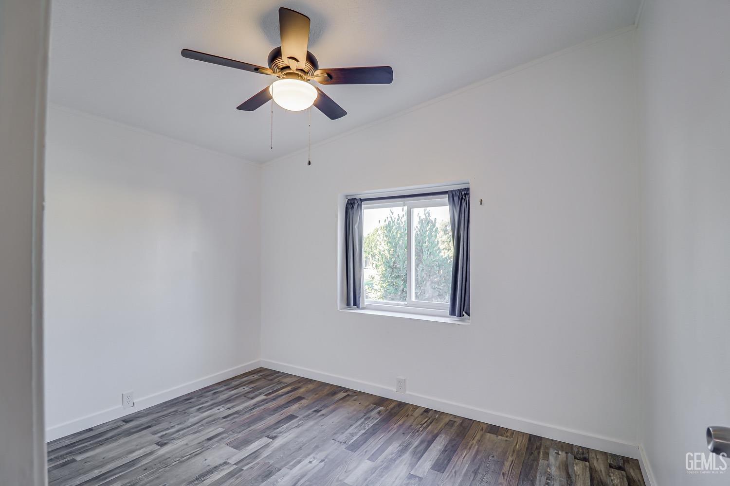 Undisclosed Address Bakersfield, CA 93314 - Photo 14 of 27 an empty room with a window and a fan