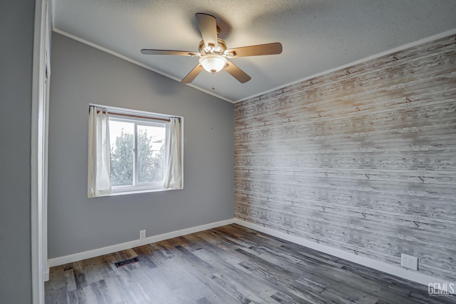 Undisclosed Address Bakersfield, CA 93314 - Photo 16 of 27 a view of an empty room with wooden floor and a window