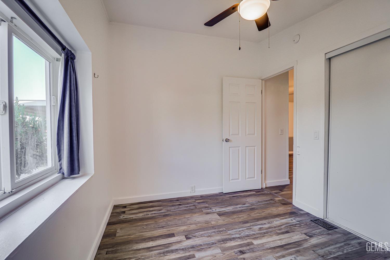 Undisclosed Address Bakersfield, CA 93314 - Photo 17 of 27 a view of room with window and wooden floor