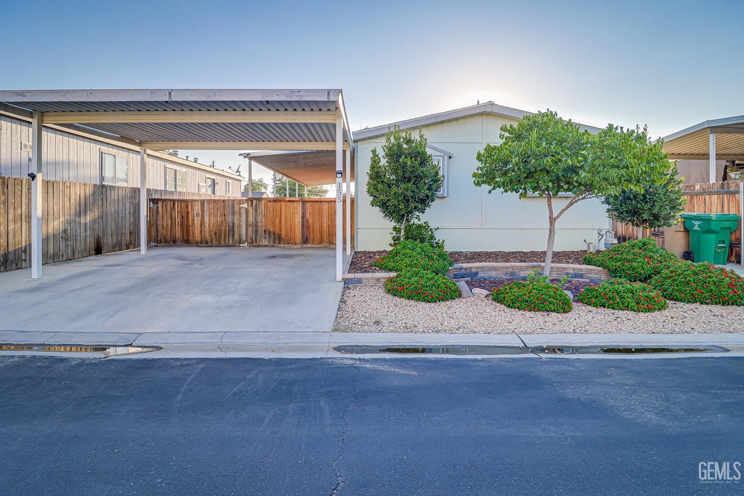 Undisclosed Address Bakersfield, CA 93314 - Photo 2 of 27 a view of a house with a yard and garage