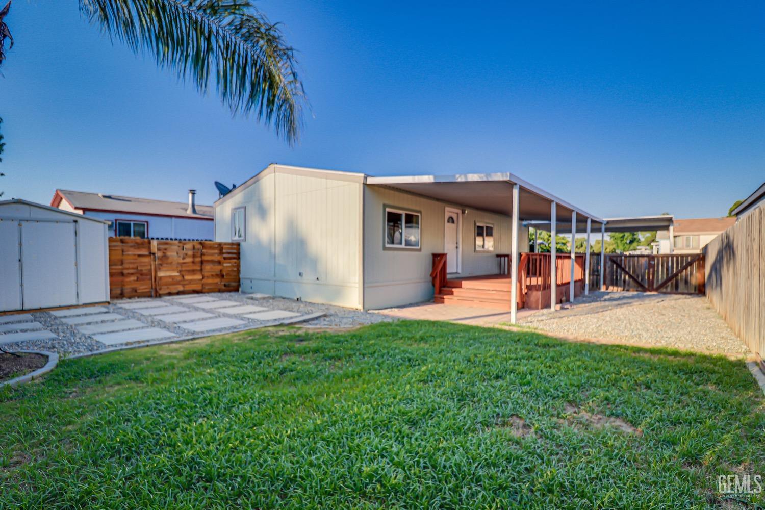 Undisclosed Address Bakersfield, CA 93314 - Photo 25 of 27 a front view of a house with a yard and garage