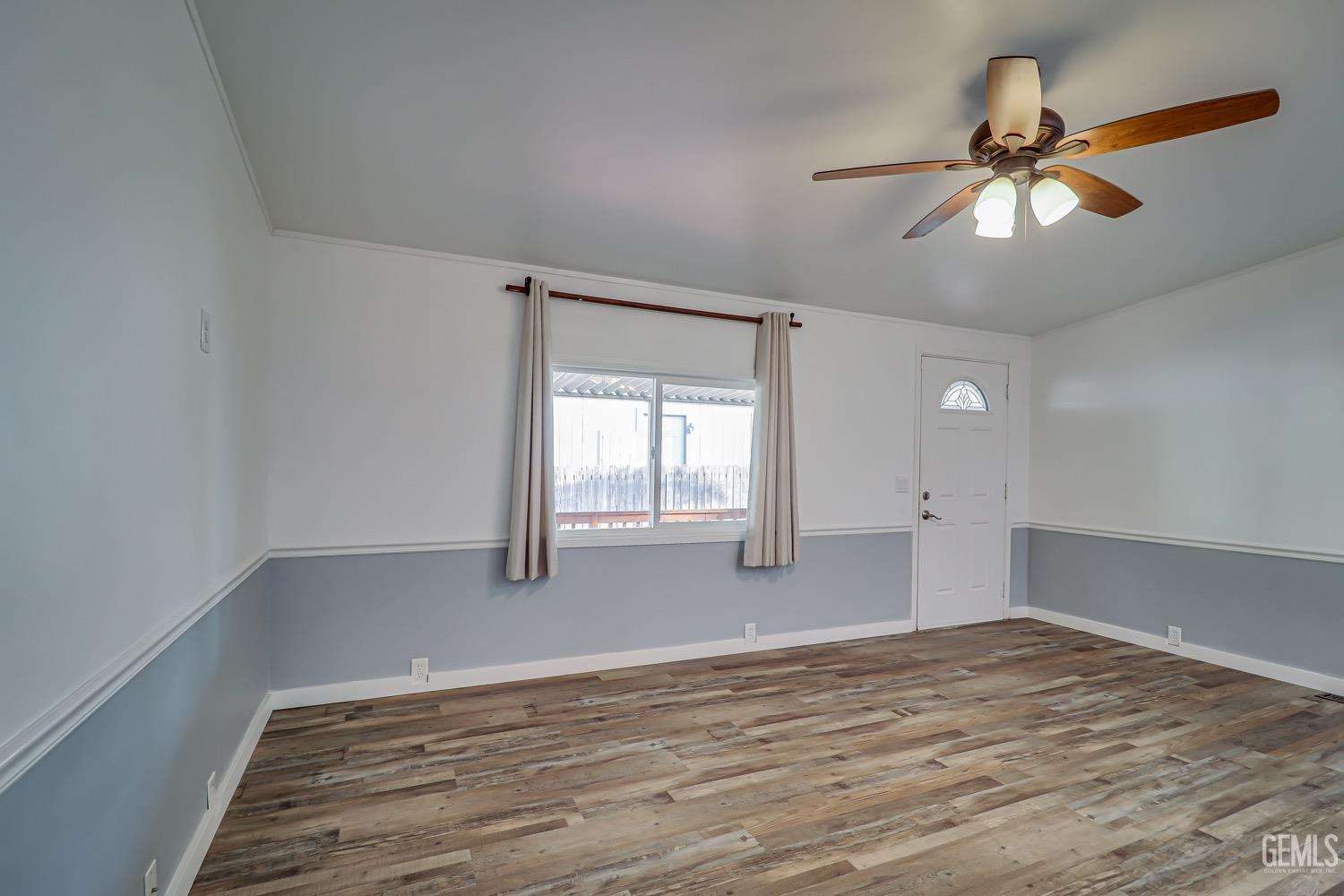 Undisclosed Address Bakersfield, CA 93314 - Photo 8 of 27 a view of empty room with wooden floor and fan