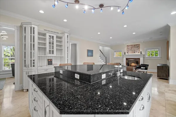 a large kitchen with granite countertop lots of counter top space and stainless steel appliances