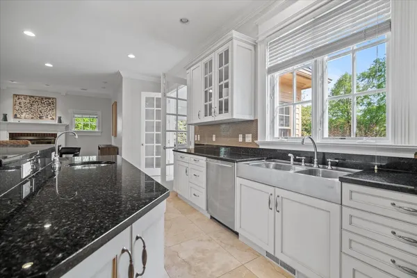 a dining room with furniture and a floor to ceiling window