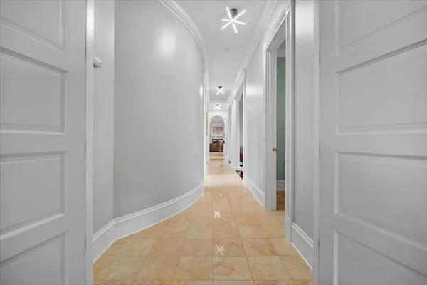 a living room with furniture a chandelier and a painting on the wall