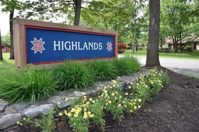 a sign that is sitting in front of flowers