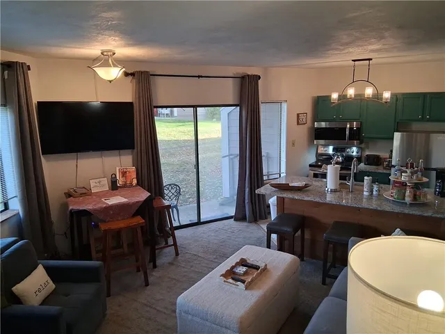 a room with furniture a flat screen tv and a view of living room