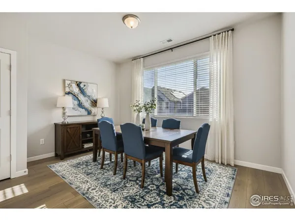 a view of a dining room with furniture and window