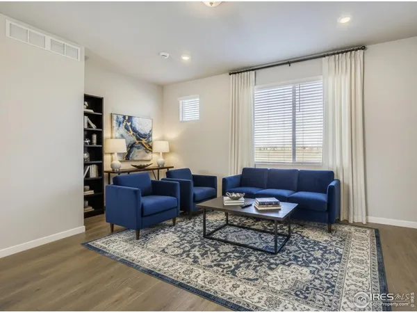a living room with furniture and a rug