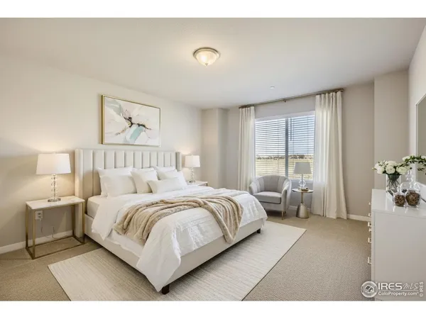 a bedroom with a bed and large window