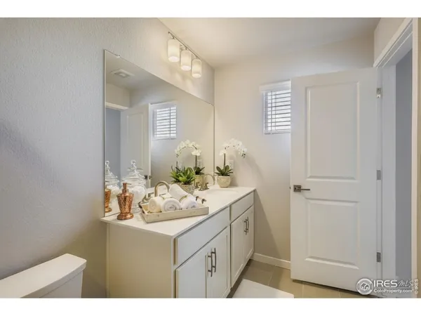 a bathroom with a sink vanity granite and a mirror