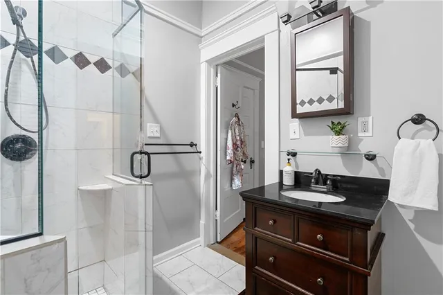 a bathroom with a sink a mirror and a shower