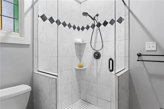 a bathroom with a shower and toilet