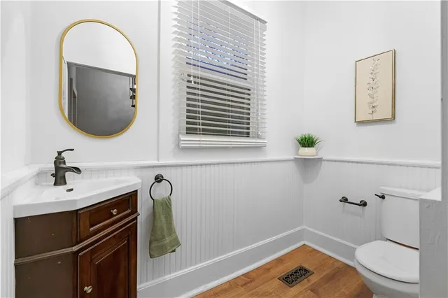 a bathroom with a sink a toilet and a mirror