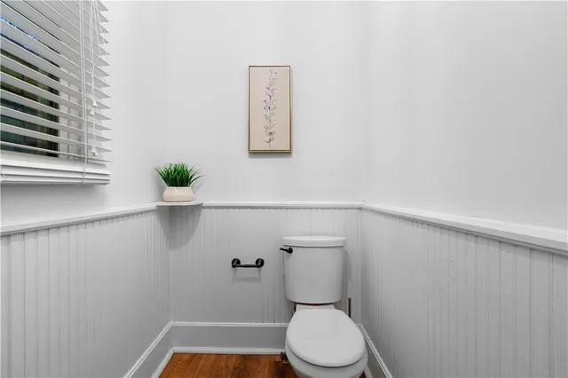 a white toilet sitting next to a window