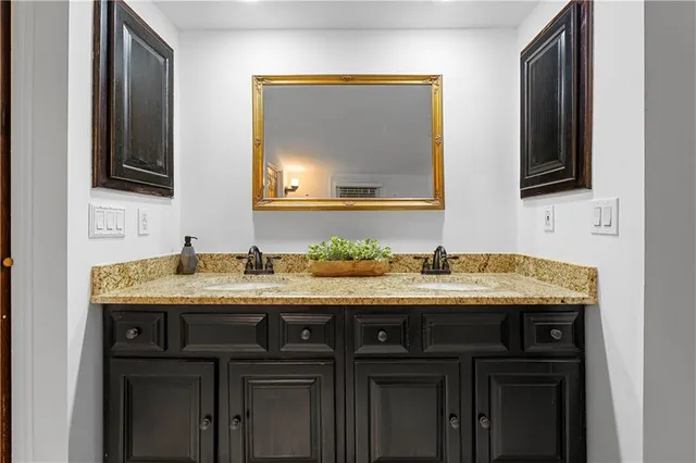 a bathroom with a granite countertop sink a mirror and a