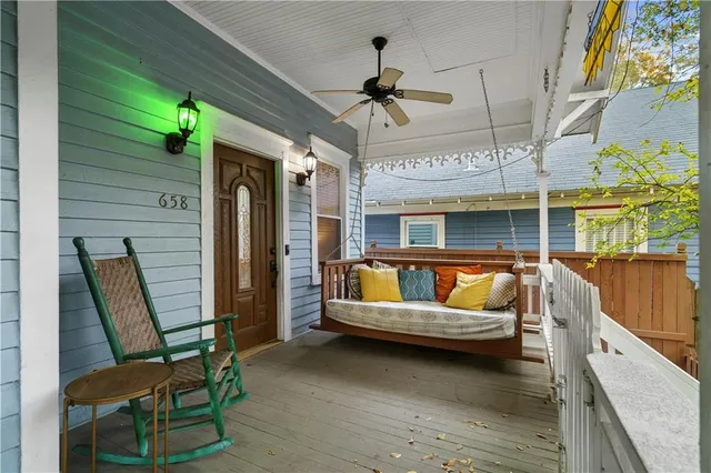 a view of a balcony with furniture and a ceiling fan