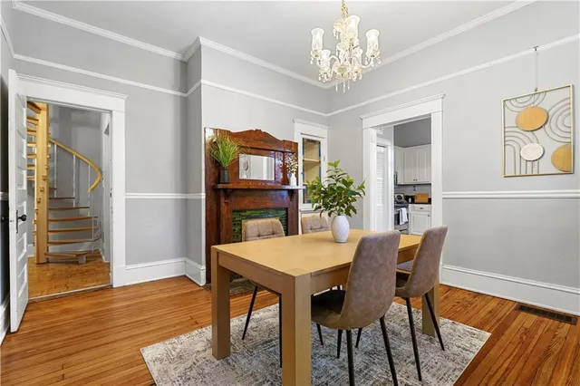 a view of a dining room with furniture wooden floor and a chandelier