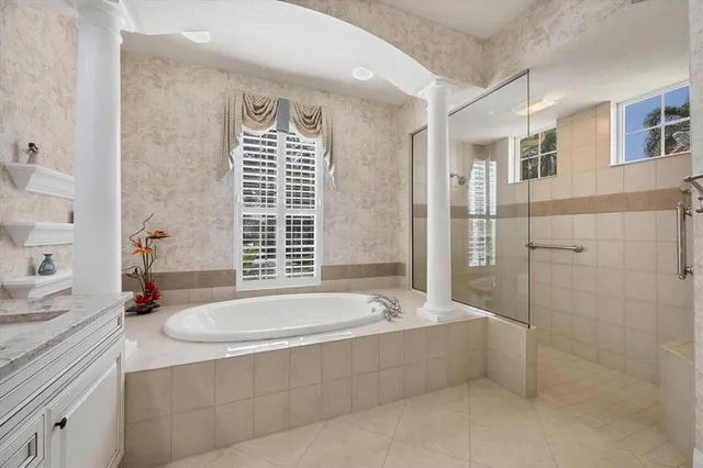 a spacious bathroom with sink shower and bathtub