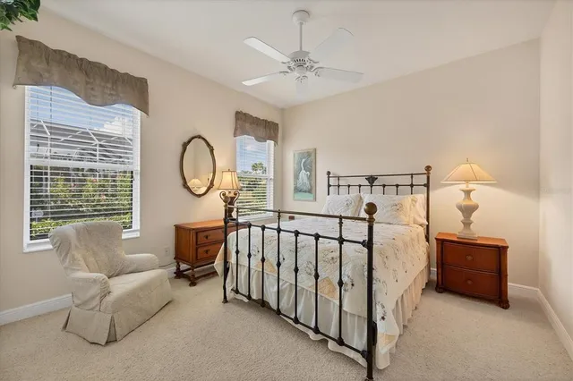 a bedroom with a bed a mirror and a window